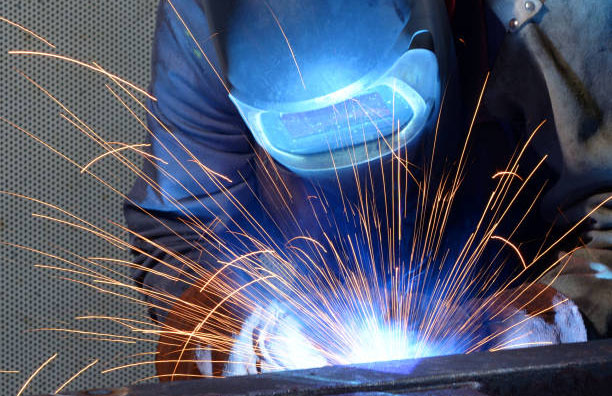 welder works in an industrial company - production of steel components